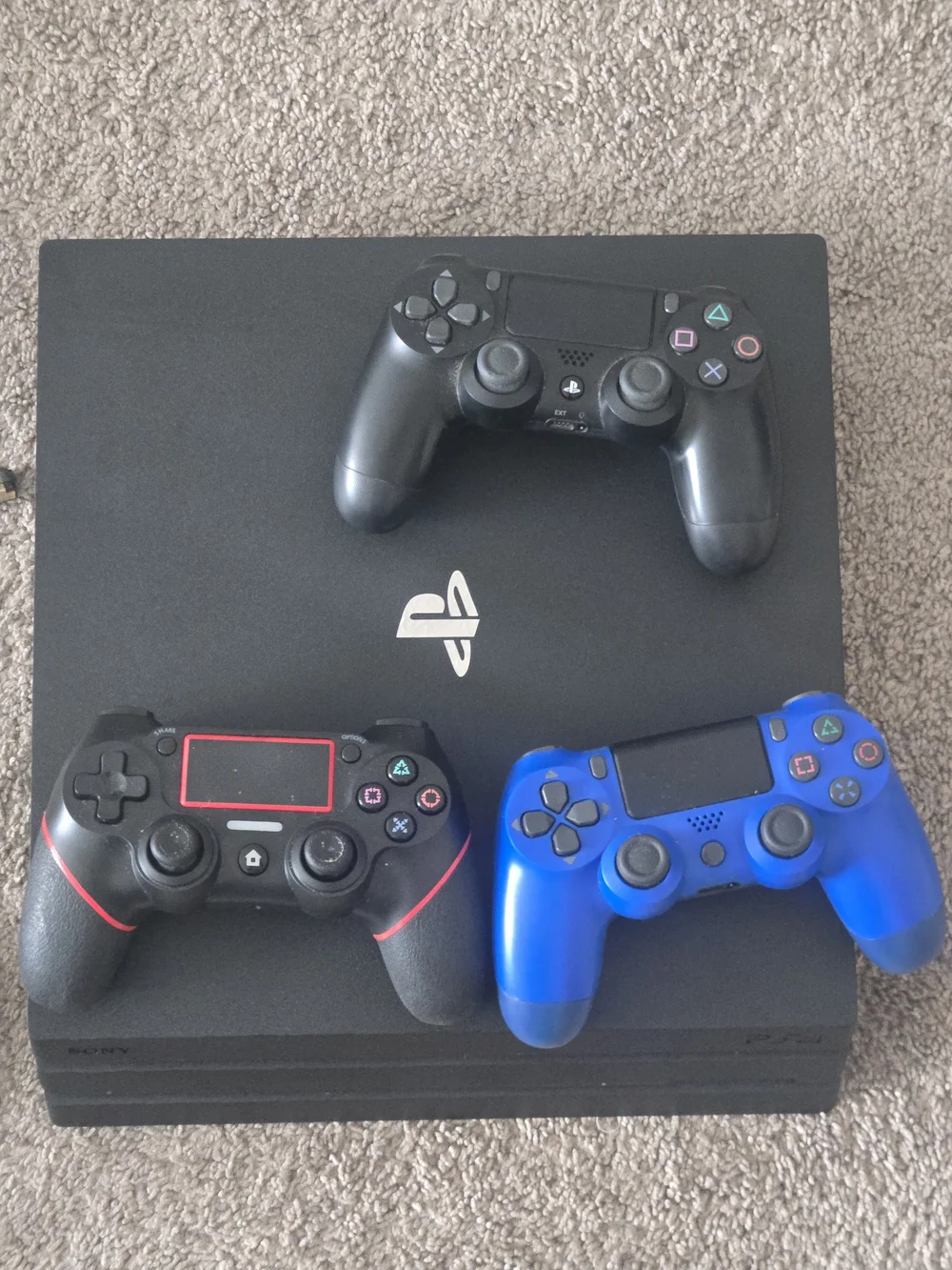 Sony 4 Slim Console with Black, Red-Accented, and Blue DualShock Controllers